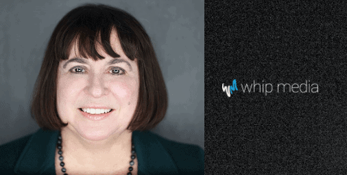 Professional woman smiling in business portrait representing Whip Media's branding and technology solutions.
