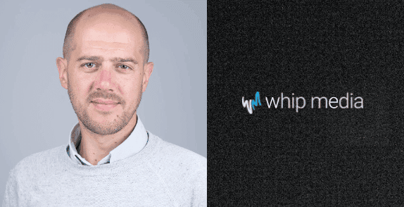 Headshot of a confident professional man with a neutral expression, wearing a light grey sweater against a plain background, representing media industry expertise.