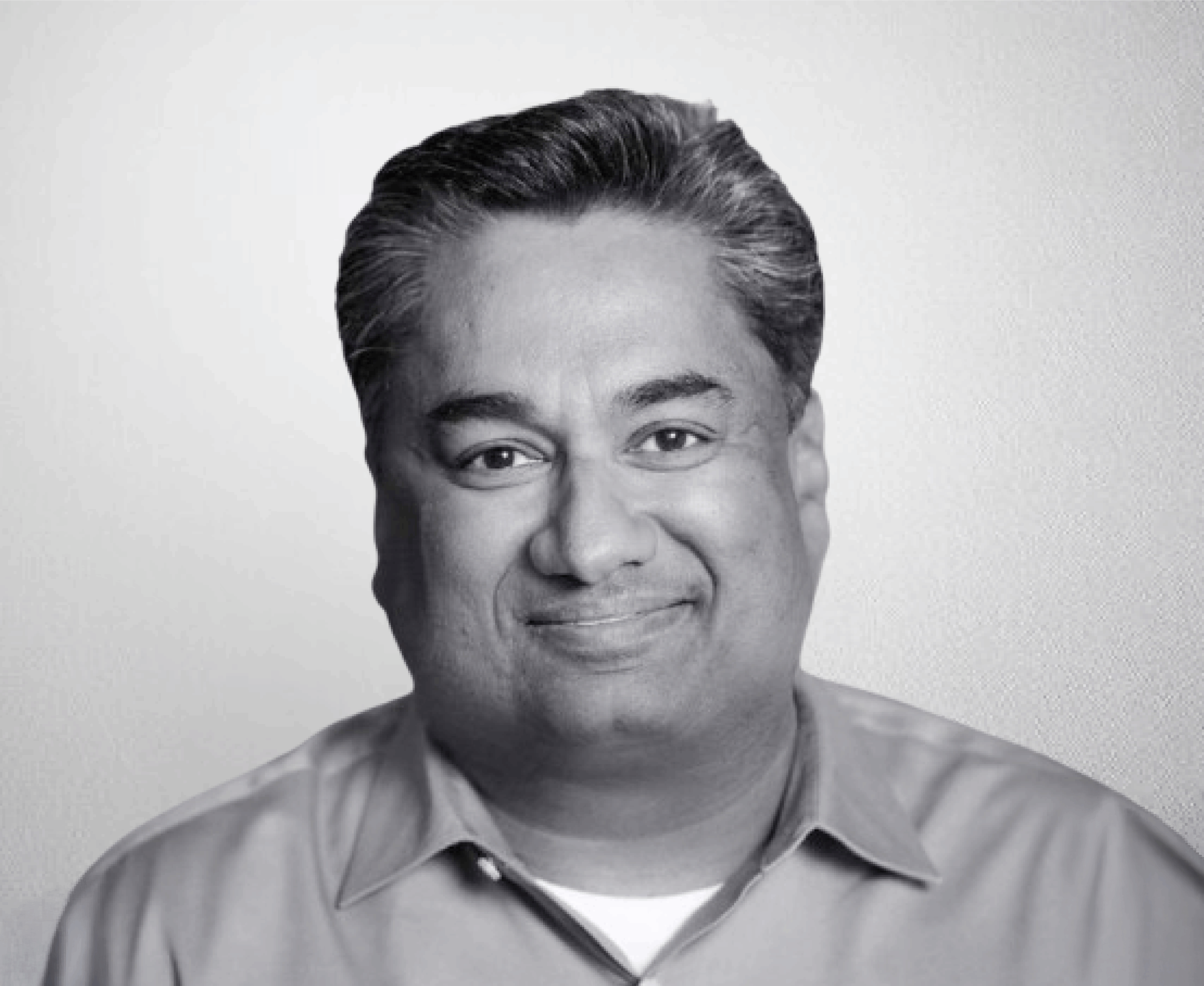 Smiling professional man portrait, black and white headshot, business attire, confident expression, high-quality corporate image for professional profiles or marketing materials.