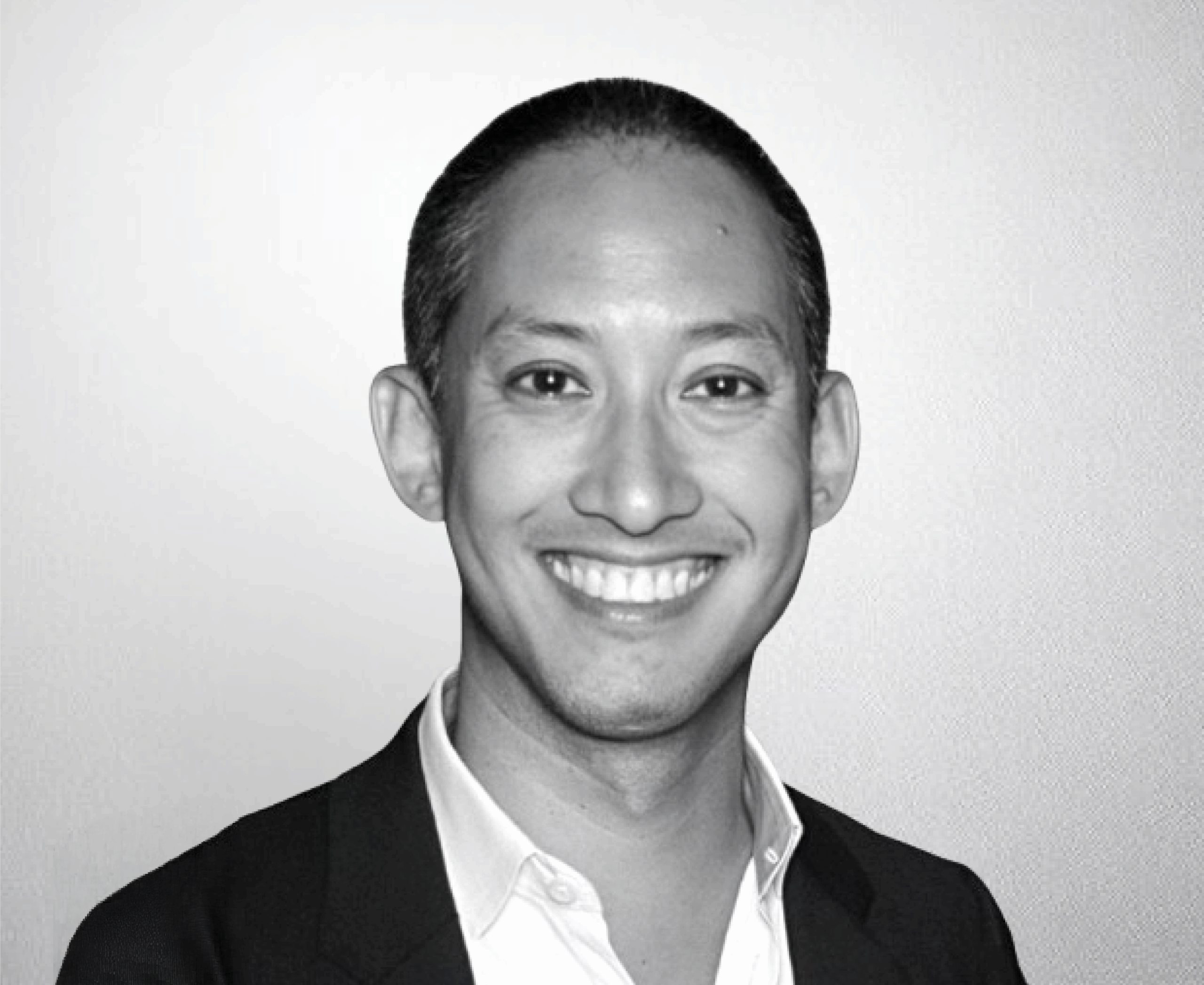 Professional Black and White Headshot of a Smiling Male Business Executive in Formal Attire for Corporate Profile Use.